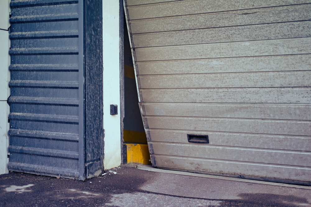 Broken,Garage,Door,For,Car,Exit,,Bent,Door,Close-up